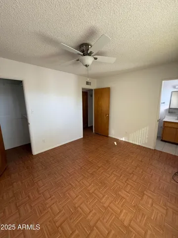 a view of a livingroom with a ceiling fan and window