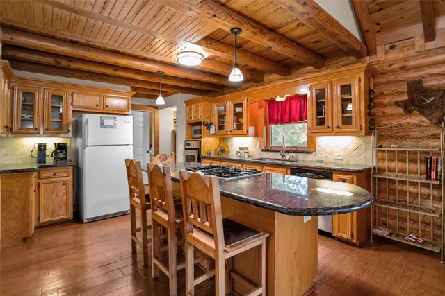 a dining table with chairs and window