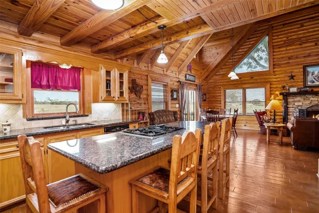 a kitchen with stainless steel appliances granite countertop a sink and cabinets