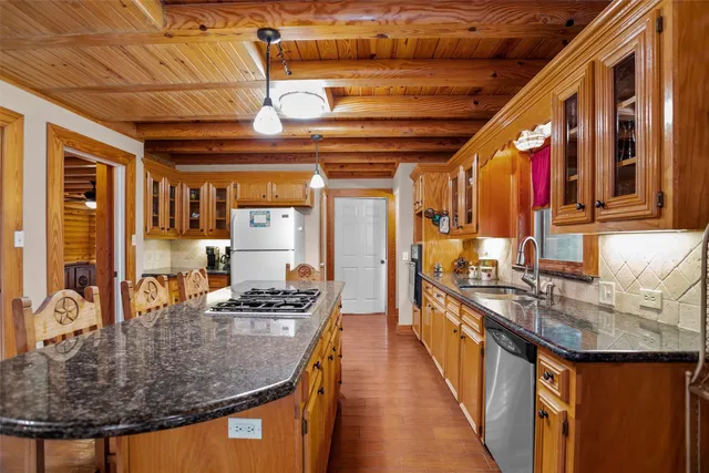 a kitchen with stainless steel appliances granite countertop a stove and a microwave