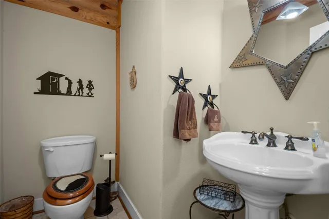 a view of a roof deck with table and chairs a barbeque with wooden floor and fence