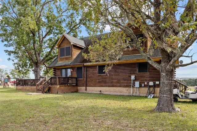a view of ocean with a table and chairs next to a yard