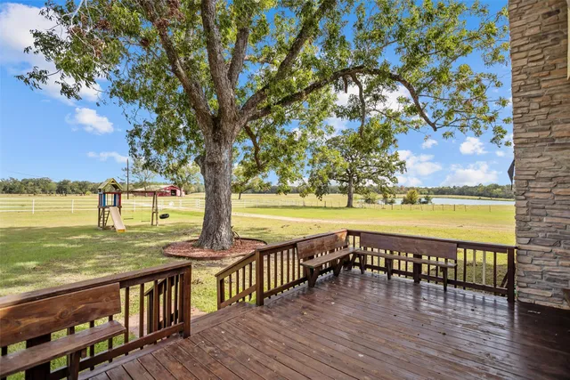 an aerial view of ocean and residential houses with outdoor space