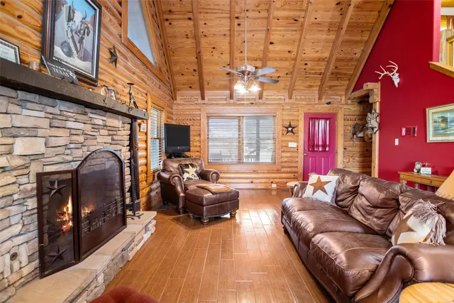 a living room with furniture a fireplace and a table