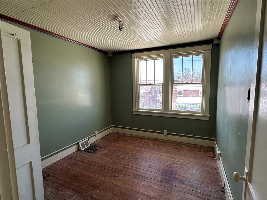 3733 Superior Street Homestead, PA 15120 - Photo 13 of 16 an empty room with wooden floor and windows