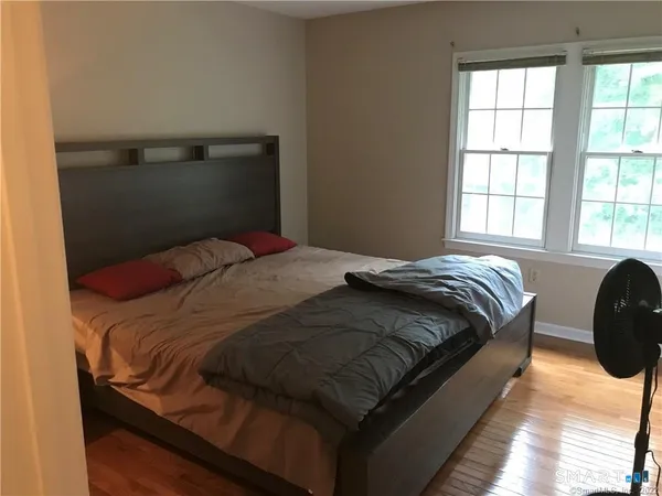a bedroom with a bed and window