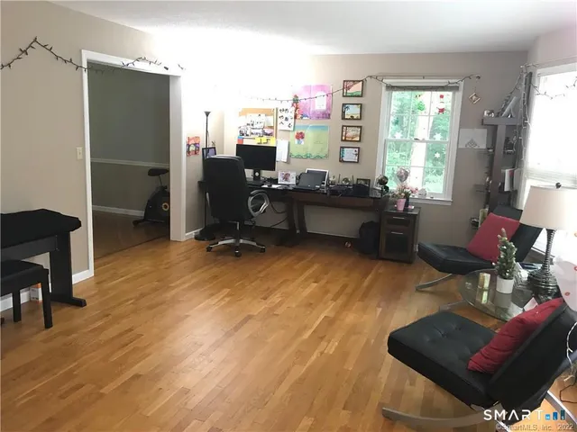 a workspace with furniture window and wooden floor