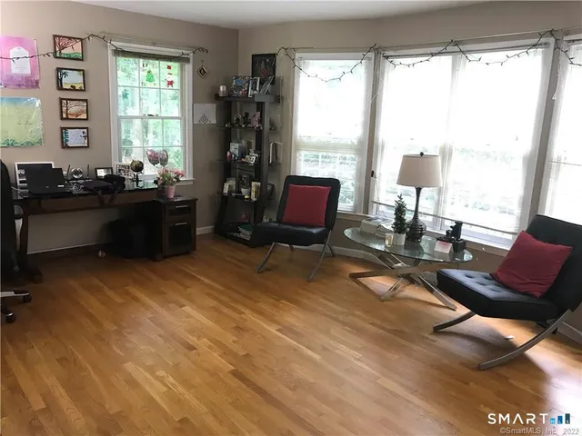 a living room with furniture and floor to ceiling window