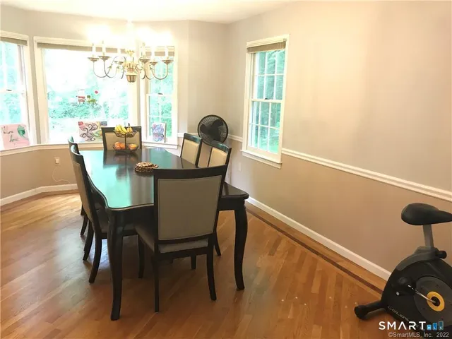 a view of a dining room with furniture window and wooden floor
