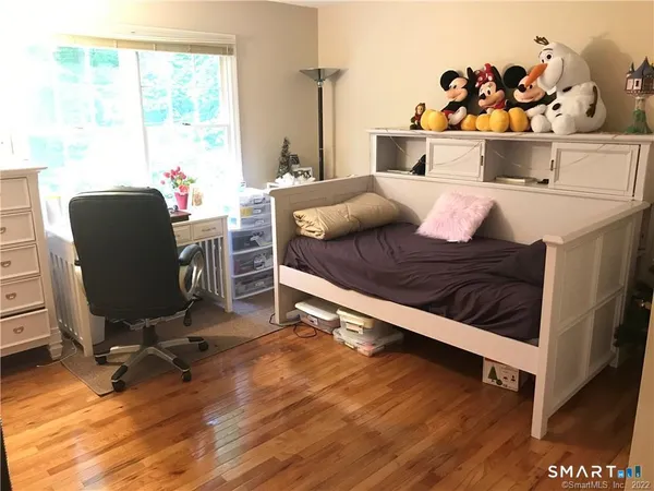 a bed room with a bed and a chair