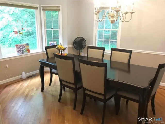 a view of a dining room with furniture and a window