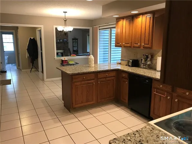 a kitchen with stainless steel appliances granite countertop a sink and cabinets