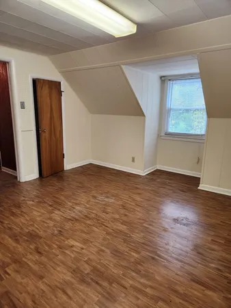 an empty room with windows and closet