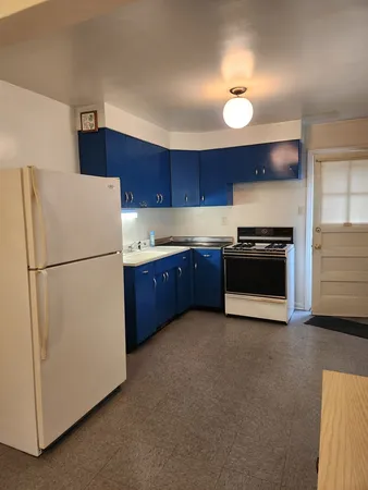 a kitchen with cabinets and stainless steel appliances
