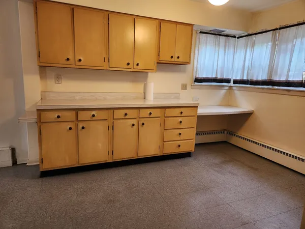 a kitchen with stainless steel appliances a stove a sink and cabinets