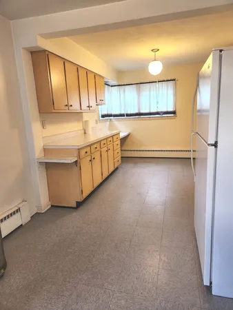 a kitchen with stainless steel appliances granite countertop a refrigerator a stove and a sink with cabinets