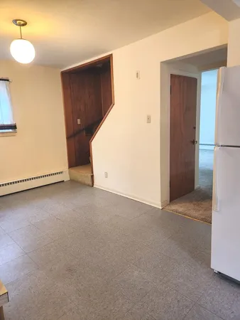 a view of an empty room with a kitchen