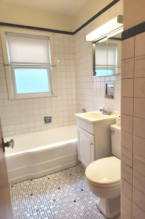 a bathroom with a toilet a sink and bathtub