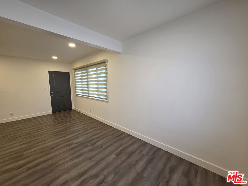707 Strand Street, Unit 3 Santa Monica, CA 90405 - Photo 15 of 42 a view of an empty room with wooden floor and a window