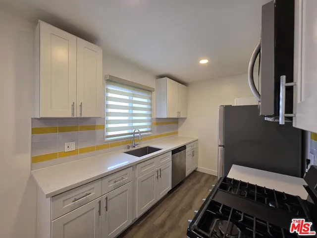 a kitchen that has a sink and a stove