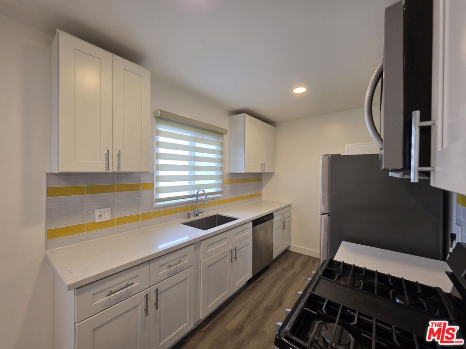 707 Strand Street, Unit 3 Santa Monica, CA 90405 - Photo 17 of 42 a kitchen that has a sink and a stove