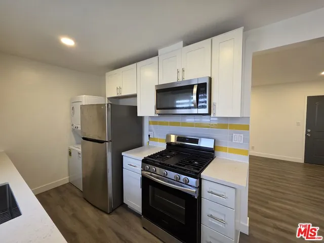 a kitchen with a refrigerator stove and microwave