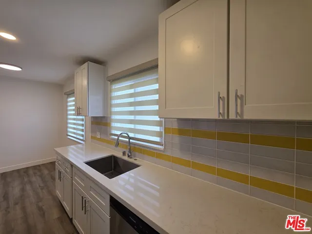 a kitchen with stainless steel appliances a sink and a stove
