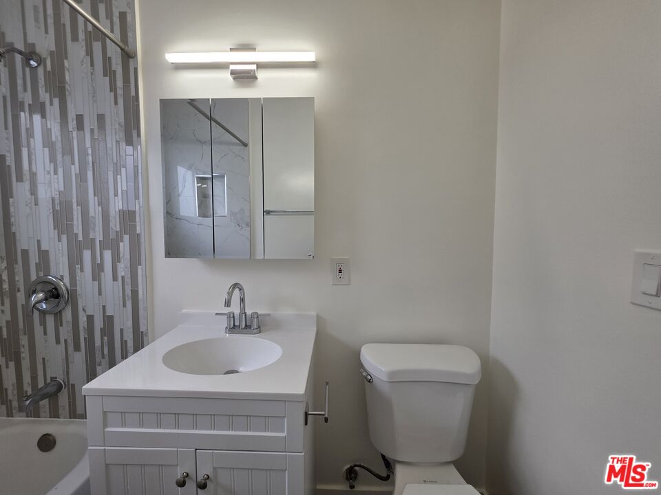 707 Strand Street, Unit 3 Santa Monica, CA 90405 - Photo 40 of 42 a bathroom with a sink toilet a mirror and shower