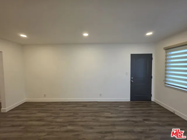 a view of room with window and wooden floor