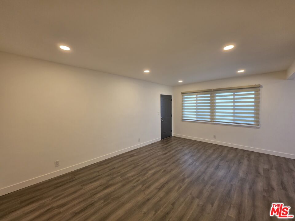 707 Strand Street, Unit 3 Santa Monica, CA 90405 - Photo 5 of 42 a view of an empty room with wooden floor and a window