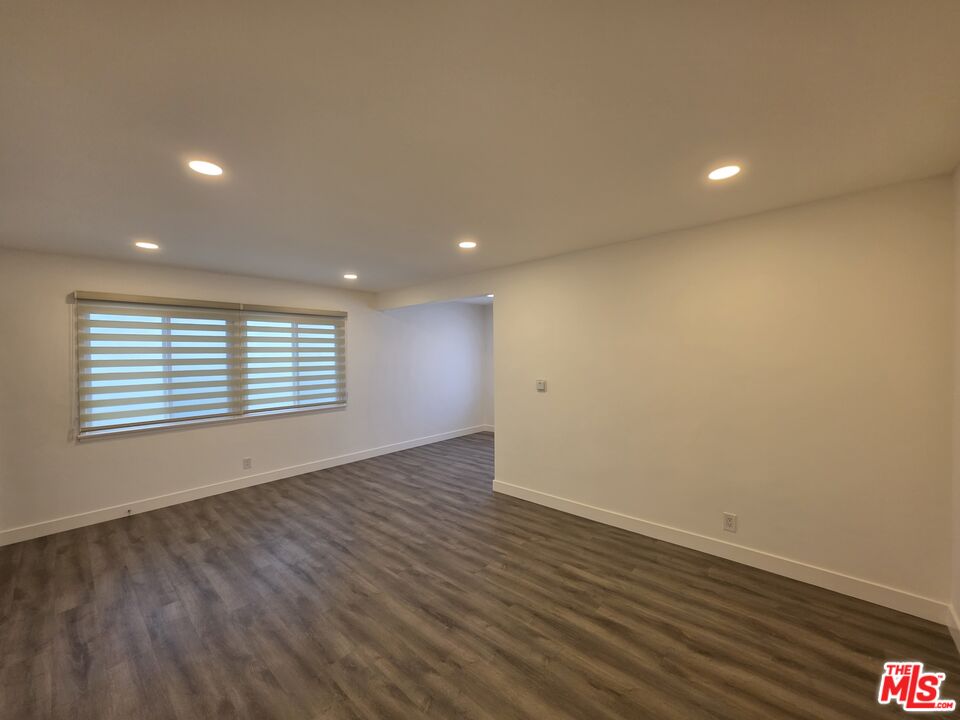 707 Strand Street, Unit 3 Santa Monica, CA 90405 - Photo 7 of 42 a view of an empty room with wooden floor and a window