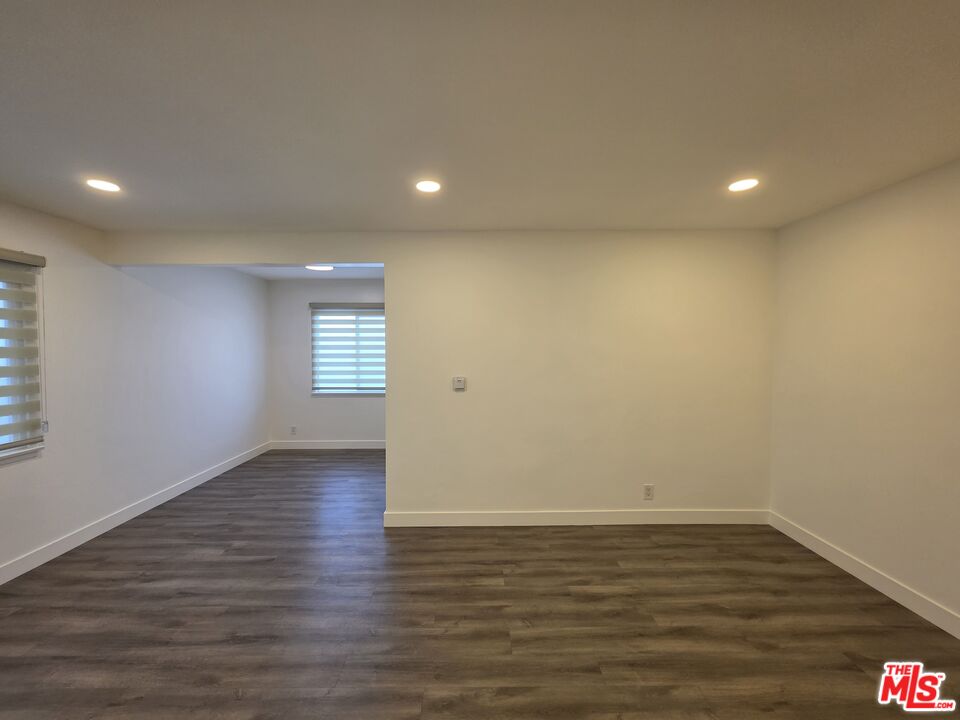 707 Strand Street, Unit 3 Santa Monica, CA 90405 - Photo 8 of 42 a view of an empty room with wooden floor and a window