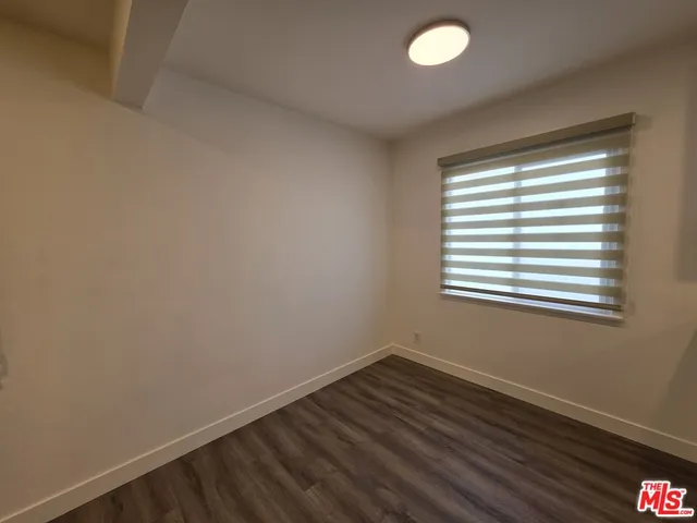a view of a room with wooden floor and windows