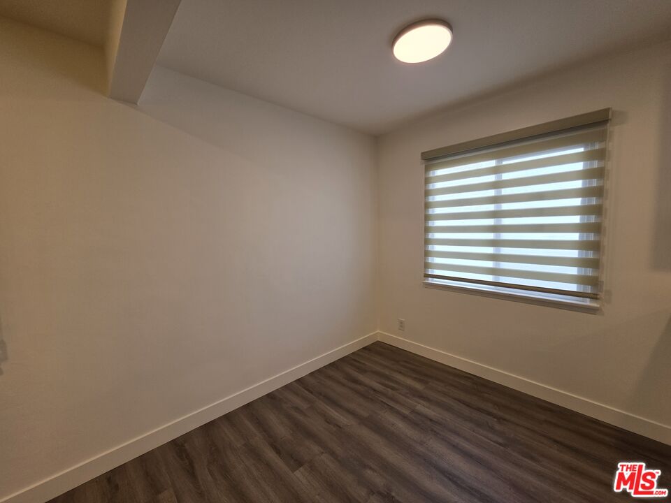707 Strand Street, Unit 3 Santa Monica, CA 90405 - Photo 9 of 42 a view of a room with wooden floor and windows