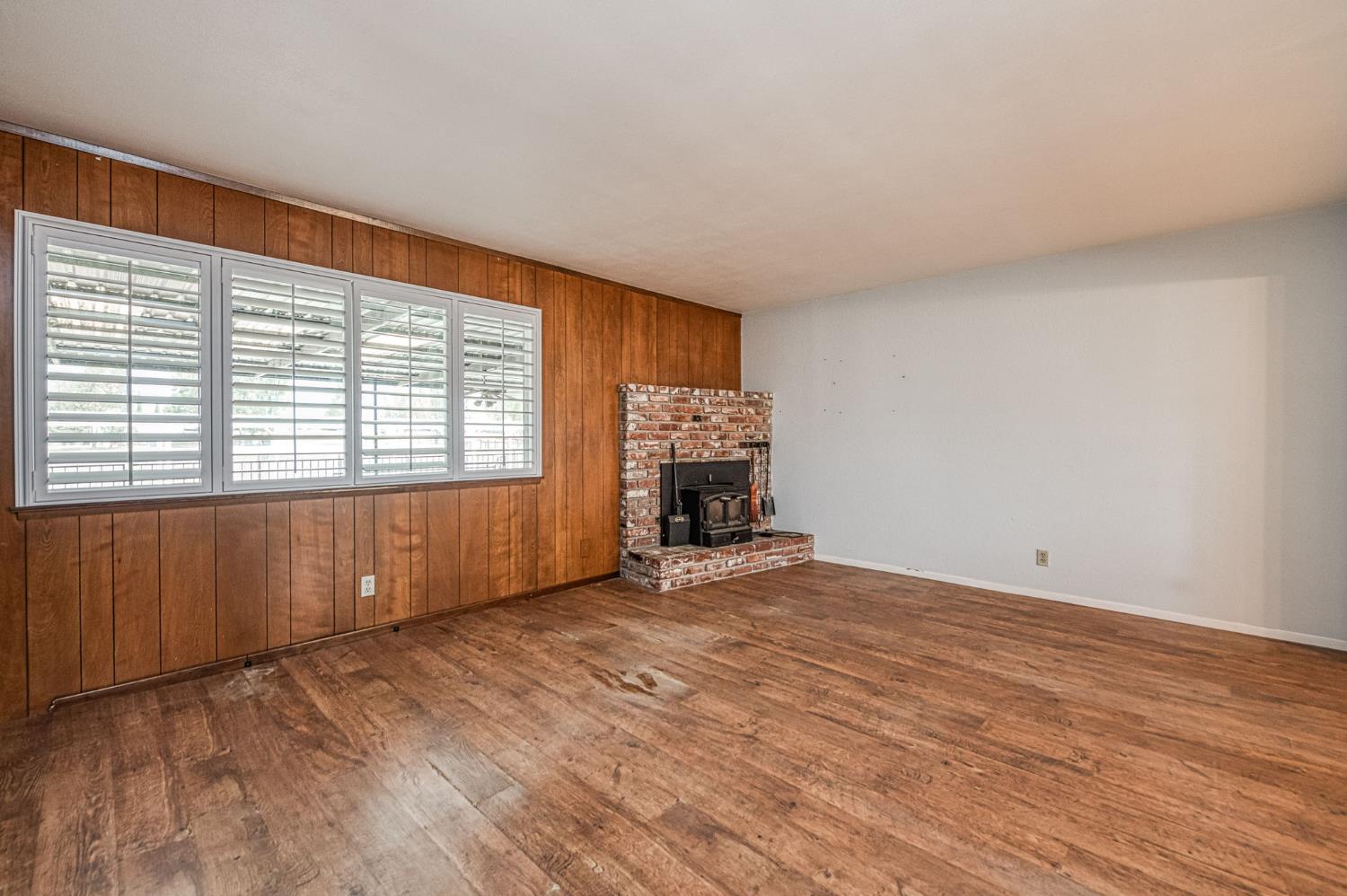 5578 Perrin Road Clovis, CA 93619 - Photo 15 of 62 a view of an empty room with wooden floor and a window