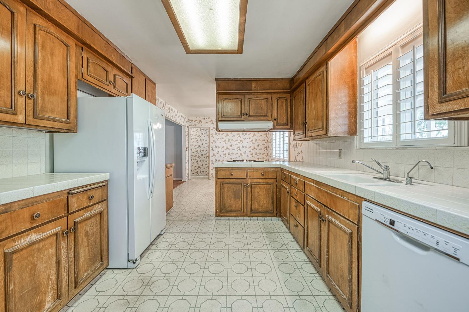 5578 Perrin Road Clovis, CA 93619 - Photo 26 of 62 a kitchen with stainless steel appliances granite countertop a refrigerator and a sink