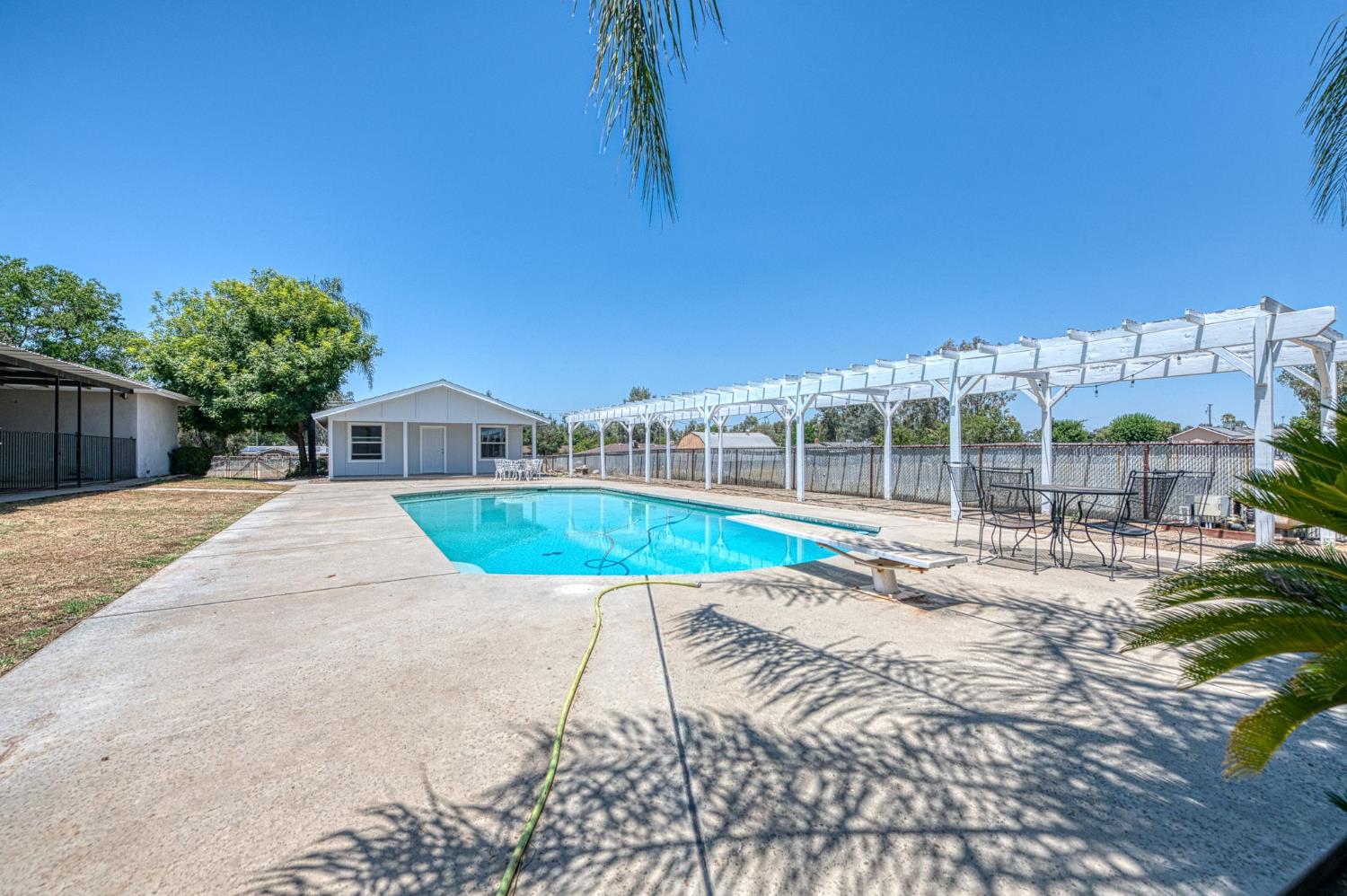 5578 Perrin Road Clovis, CA 93619 - Photo 44 of 62 a view of swimming pool with a yard