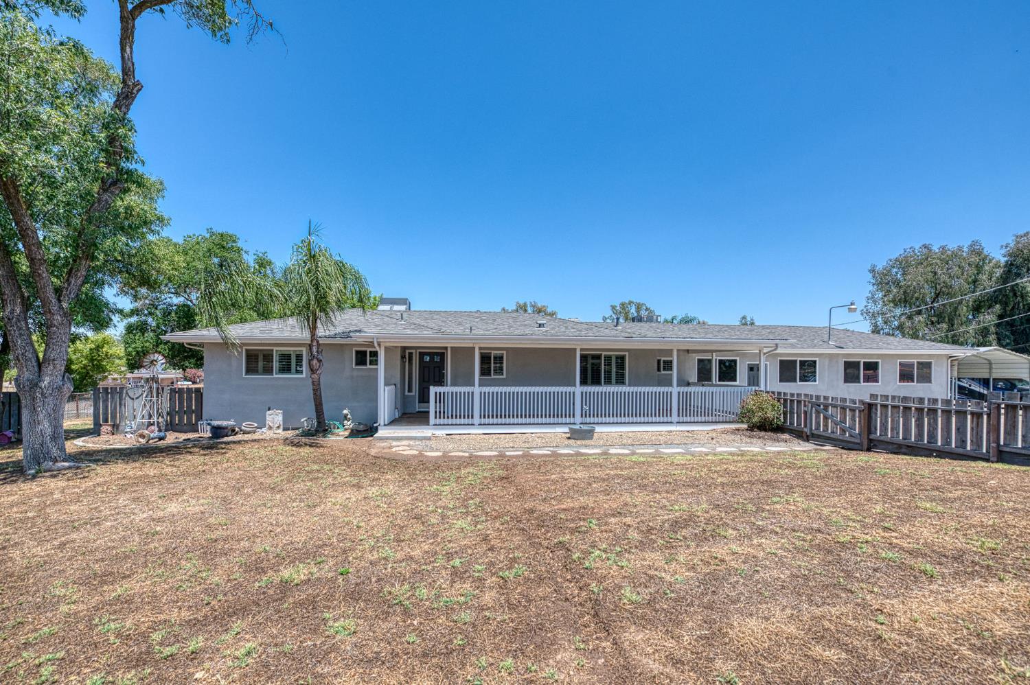 5578 Perrin Road Clovis, CA 93619 - Photo 60 of 62 a view of a house with a big yard and large trees