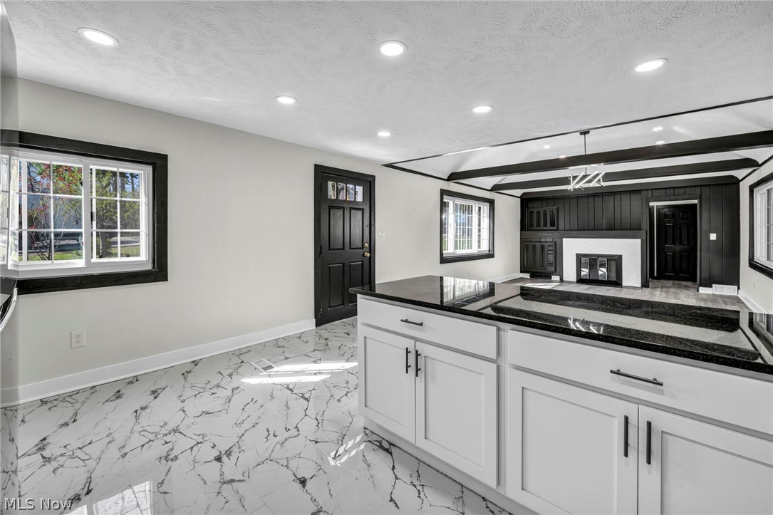 7339 River Road Olmsted Falls, OH 44138 - Photo 14 of 45 Kitchen island with dark countertop and white cabinetry