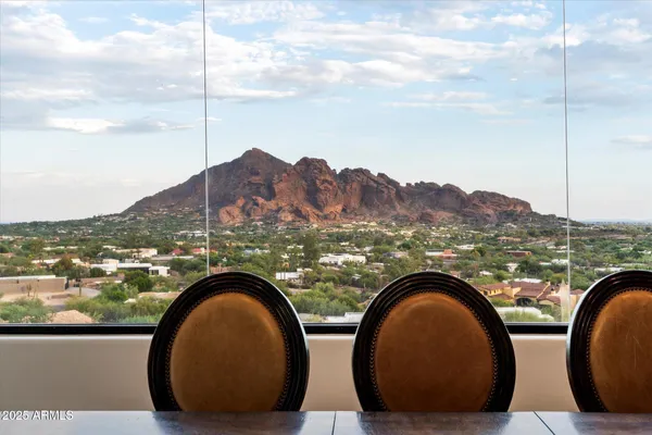 a living room with furniture a flat screen tv and a large window