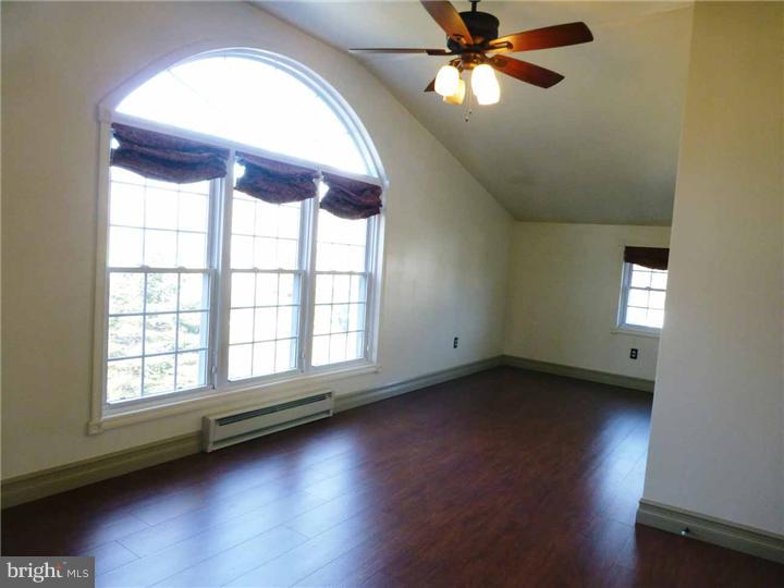 68 Bethel Church Road Spring City, PA 19475 - Photo 20 of 23 an empty room with wooden floor fan and windows