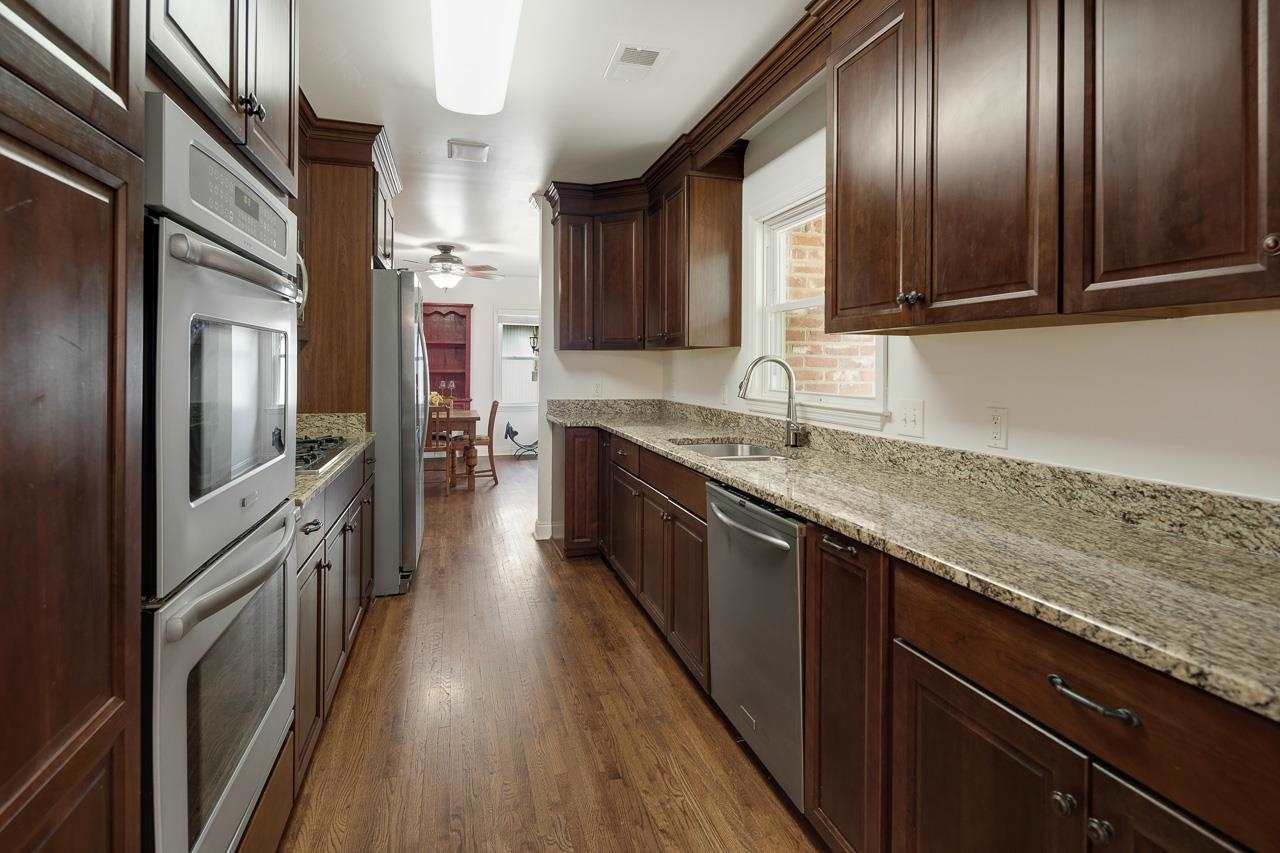 1057 Dearing Road Memphis, TN 38117 - Photo 12 of 25 Totally renovated kitchen with cabinets that go to the ceiling, granite countertops, double ovens, and cooktop.