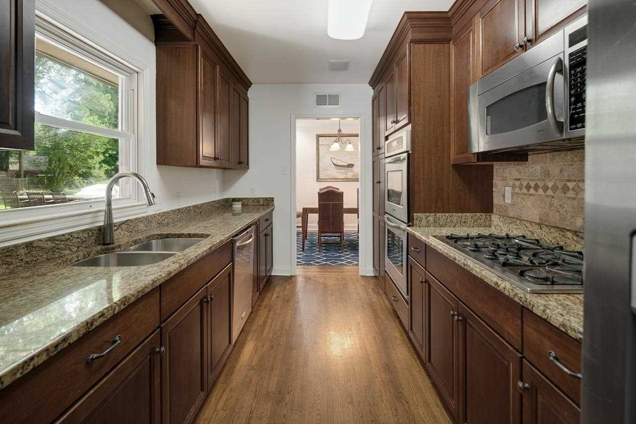 1057 Dearing Road Memphis, TN 38117 - Photo 13 of 25 The charm of the kitchen is the window over the sink that looks out into the backyard.