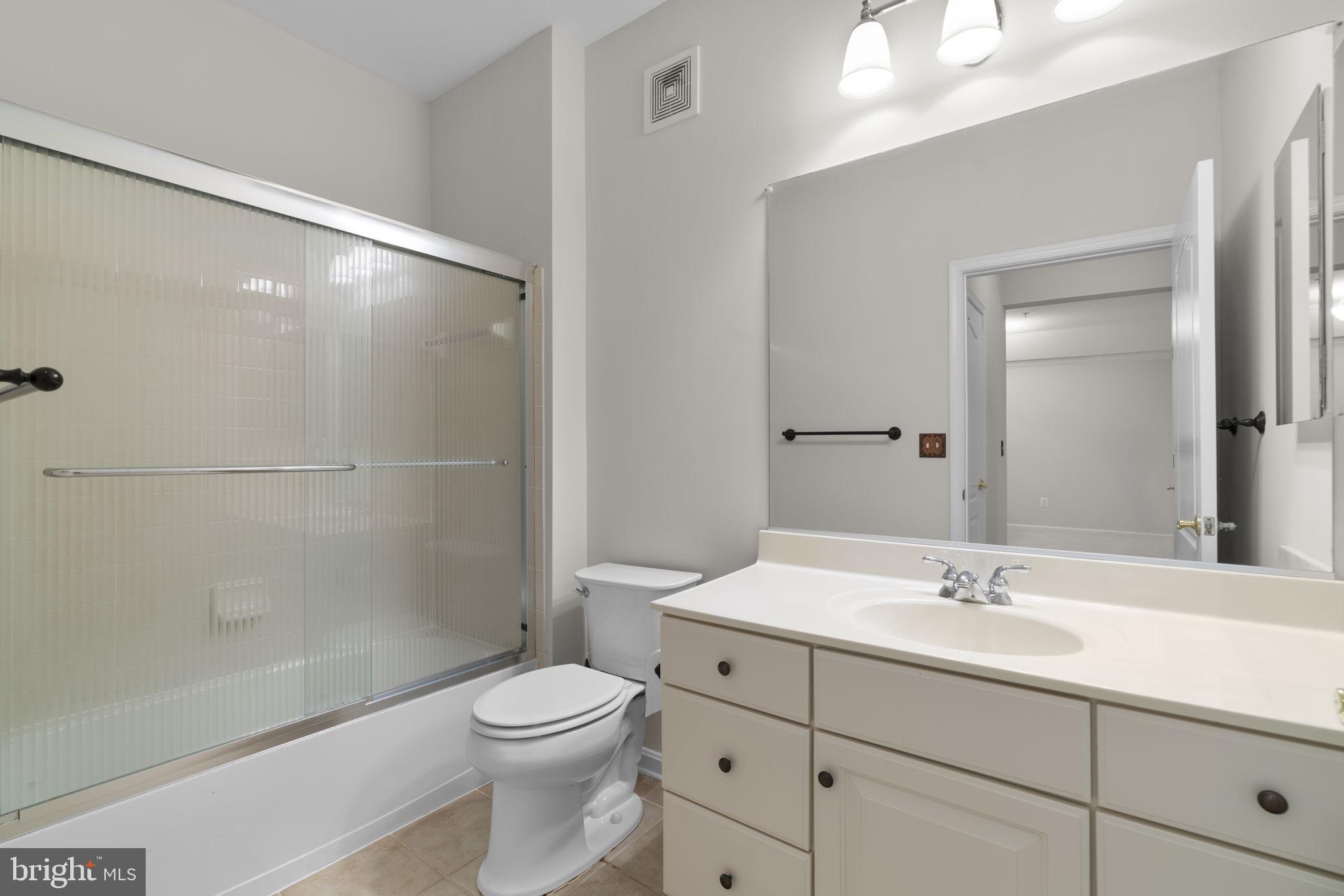 7315 Maplecrest Road, Unit 104 Elkridge, MD 21075 - Photo 41 of 58 a bathroom with a sink a toilet and shower