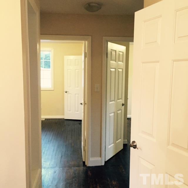 722 Newcombe Road Raleigh, NC 27610 - Photo 13 of 19 a view of an empty room with wooden floor and a window