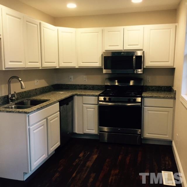 722 Newcombe Road Raleigh, NC 27610 - Photo 4 of 19 a kitchen with stainless steel appliances a stove a microwave and cabinets