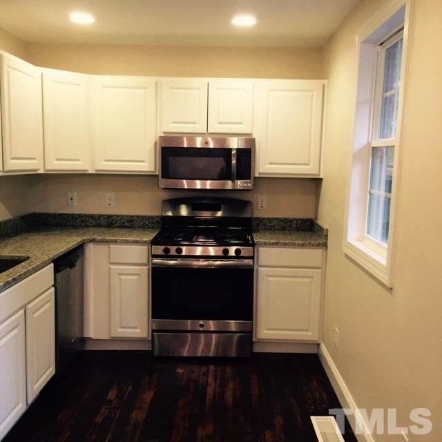 722 Newcombe Road Raleigh, NC 27610 - Photo 5 of 19 a kitchen with a stove and a microwave