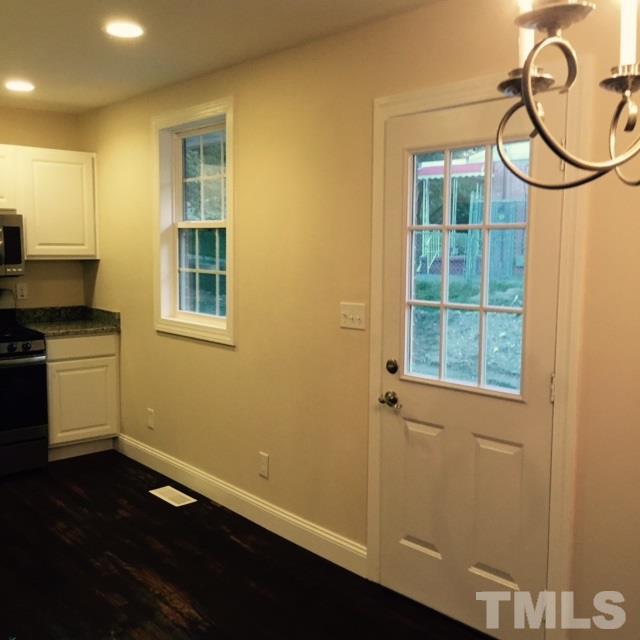 722 Newcombe Road Raleigh, NC 27610 - Photo 7 of 19 an empty room with wooden floor and windows