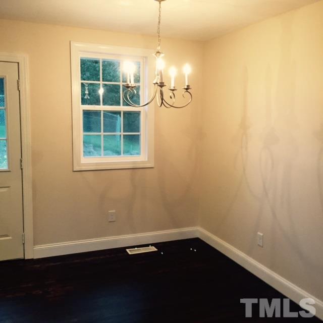 722 Newcombe Road Raleigh, NC 27610 - Photo 8 of 19 a view of a room with wooden floor and windows