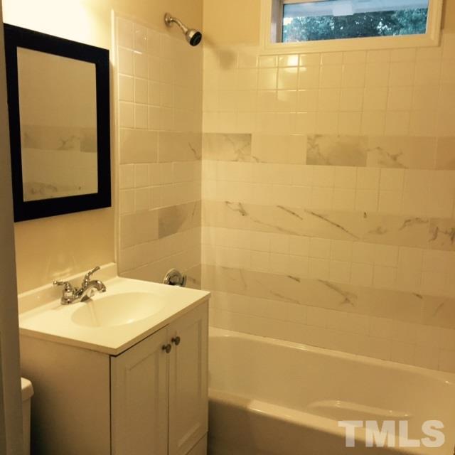 722 Newcombe Road Raleigh, NC 27610 - Photo 9 of 19 a bathroom with a sink mirror and shower